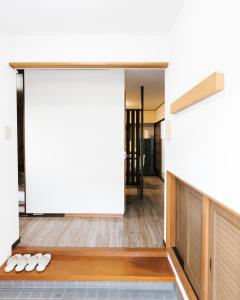 two pairs of white shoes on the floor of a room at B&B MIKAWA 3 - Kanazawa Fish Harbour in Kanazawa