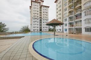a large swimming pool in front of two tall buildings at JC Private Apartment Sunshine Bay in Port Dickson