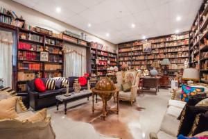 a living room filled with lots of books at Hotel Boutique Casa Garay in Oaxaca City