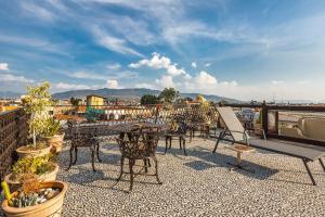 a patio with tables and chairs on a roof at Hotel Boutique Casa Garay in Oaxaca City
