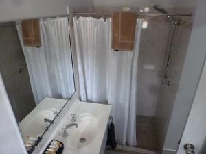 a bathroom with a sink, shower, and toilet at Aspley Carsel Motor Inn in Brisbane
