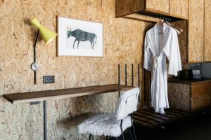 a room with a table and a cow on a wall at Ovolo Nishi in Canberra