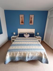 sypialnia z łóżkiem z niebieską ścianą w obiekcie CARPE DIEM Studio w mieście Benalmádena