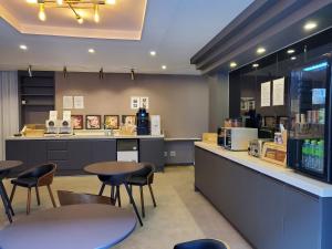 a restaurant with tables and chairs and a counter at The Stone Bridge Hotel Sasang in Busan