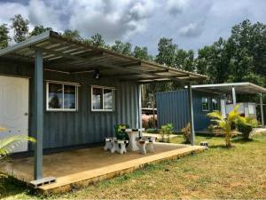 a tiny house with a porch and a patio at น็อคดาวน์ in Khao Kho