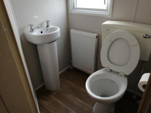 a bathroom with a toilet and a sink at 617 seawick in Jaywick Sands