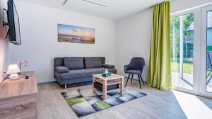 ein Wohnzimmer mit einem Sofa und einem Tisch in der Unterkunft Wiek-Resort in Wiek auf Rügen 