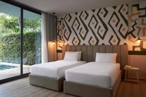 Postel nebo postele na pokoji v ubytování The Peri Hotel Khao Yai