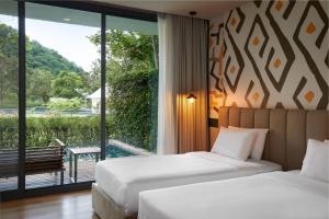 Postel nebo postele na pokoji v ubytování The Peri Hotel Khao Yai