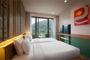 Postel nebo postele na pokoji v ubytování The Peri Hotel Khao Yai