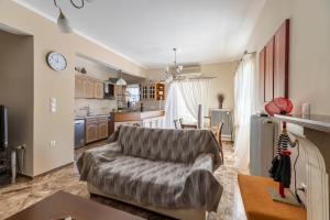 a living room with a couch and a kitchen at Castellano Monemvasia in Monemvasia