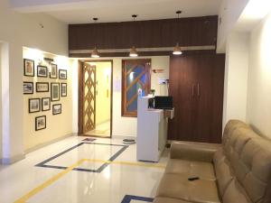 a living room with a couch and a door at Grand Suites Srirangam in Tiruchchirāppalli
