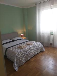 a bedroom with a bed with two towels on it at Lux in Padova