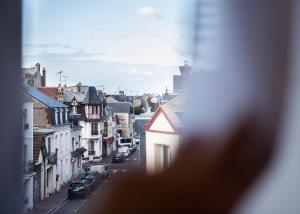 a view from a window of a city street at You Hotels Deauville - Handwritten Collection in Deauville