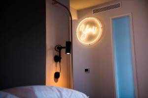 a neon sign that says your on a bedroom door at You Hotels Deauville - Handwritten Collection in Deauville