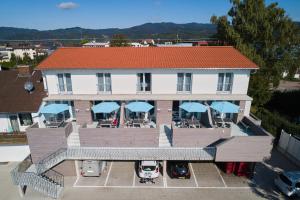 an aerial view of a building with cars parked in a parking lot at Boutique Apartments Kirchzarten in Kirchzarten