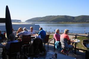 
people sitting around a picnic table at Lagoon Lodge in Knysna
