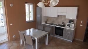 a kitchen with a white table and a table and chairs at Villa Galati Resort in Mascali +36 photos