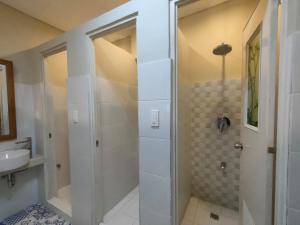 a bathroom with a shower and a sink at 538 Dormitel in Manila