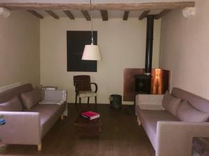 a living room with two couches and a table at Maisons de Vignerons in Noyers