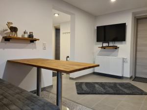 a living room with a table and a flat screen tv at wohnung-nummer-1 in Pielenhofen