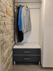 a closet with a dresser and a brick wall at wohnung-nummer-1 in Pielenhofen
