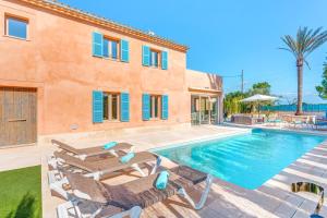 a villa with a swimming pool and a house at Ca na Rossa in Sineu