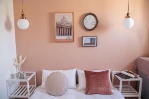 a bedroom with a bed and a clock on the wall at September in Tainan