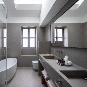 a bathroom with a sink, toilet and bathtub at Hotel Arbaso in San Sebastián