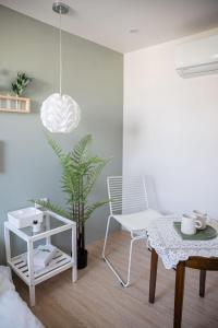 a living room with a white chair and a table at September I 國華街住宿 in Tainan