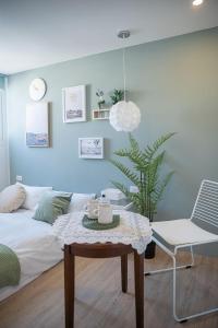 a living room with a table and a bed at September I 國華街住宿 in Tainan