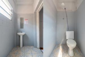 a bathroom with a toilet and a sink at Hotel Mogi in Mogi das Cruzes +6 photos