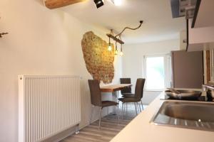 a kitchen and dining room with a table and chairs at Ferienwohnung Fischach in Fischach