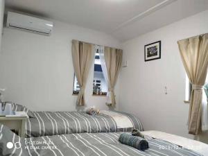 Postel nebo postele na pokoji v ubytování guest house 鎌倉記憶