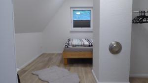 a small bedroom with a bed and a window at Forsthaus Timmerloher Weg in Schneverdingen