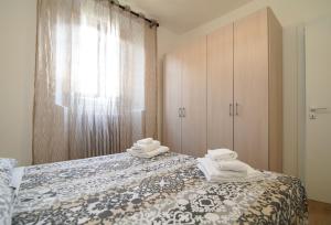 Postel nebo postele na pokoji v ubytování Conte Durini Apartments & Rooms