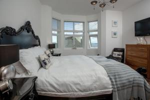 a bedroom with a large bed and a television at The Penthouse 15 At the Beach, Torcross in Beesands