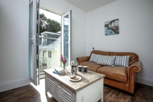 a living room with a couch and a coffee table at The Penthouse 15 At the Beach, Torcross in Beesands
