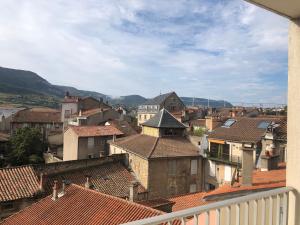 a view of a town with roofs and buildings at Ibis Centre Millau in Millau