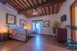 a bedroom with a bed and a ceiling fan at Lemon Tree Boutique Guest House in Todi
