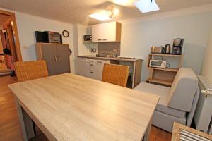 a kitchen with a table and chairs in a room at Ferienwohnungen Greifswald_Wieck V in Wieck