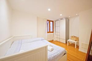 a white bedroom with a bed and a window at DolceVita Apartments N. 479 in Venice