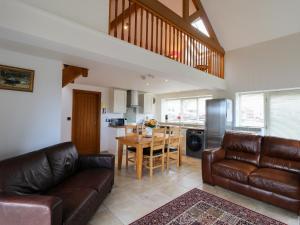 a living room with a couch and a table at Mallard Cottage in Whitby