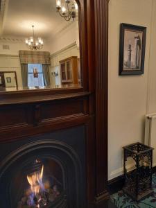 a living room with a fireplace and a fire place at The Parliament House Hotel in Edinburgh