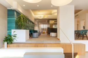 a living room with a staircase and a lobby at Albatros Beach Hotel in Letojanni