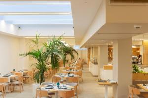 a row of tables and chairs in a restaurant at Albatros Beach Hotel in Letojanni