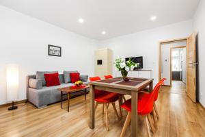 a living room with a table and chairs and a couch at Sunny Apartment Gdansk in Gdańsk