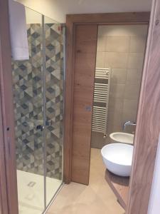 a bathroom with a glass shower and a sink at Hotel alle Rose in Cavedago