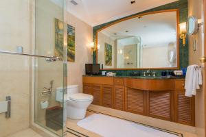 a bathroom with a shower and a toilet and a sink at The Oberoi Bengaluru in Bengaluru
