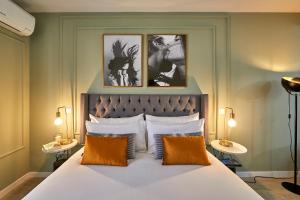 a bedroom with a large white bed with two tables at L&H La Latina Selection in Madrid